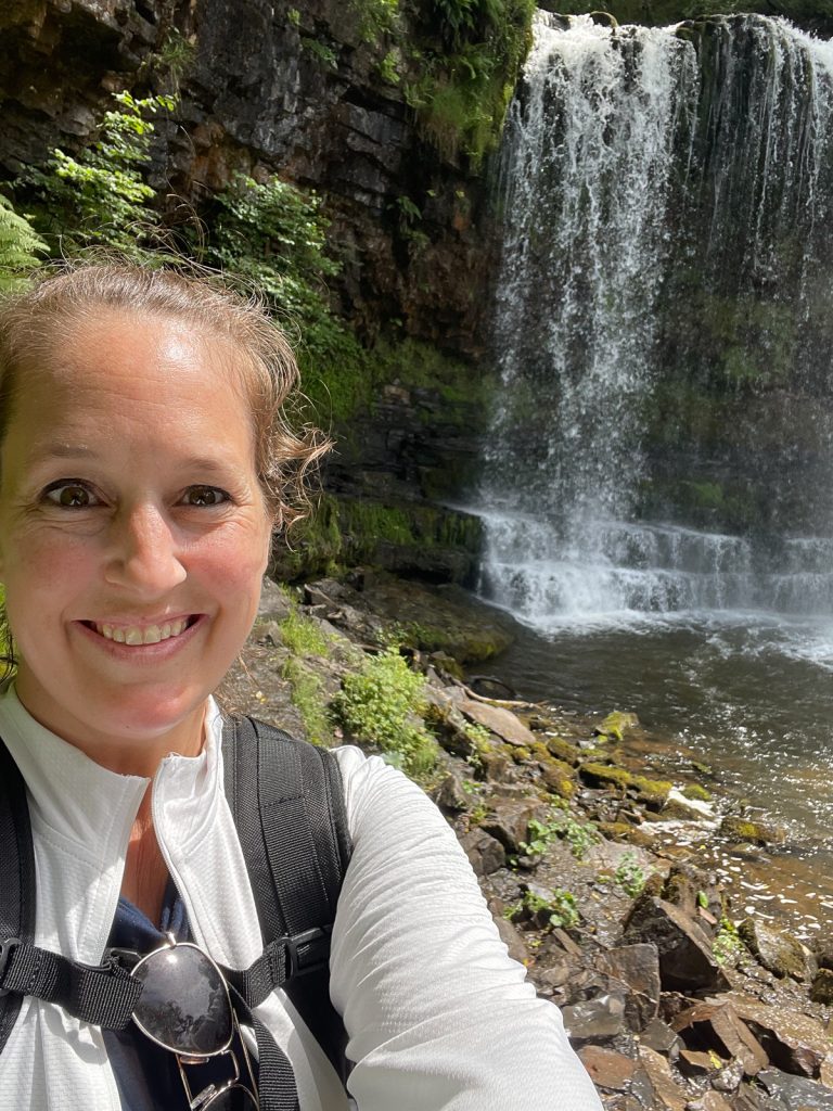 Solo travel selfie by waterfall