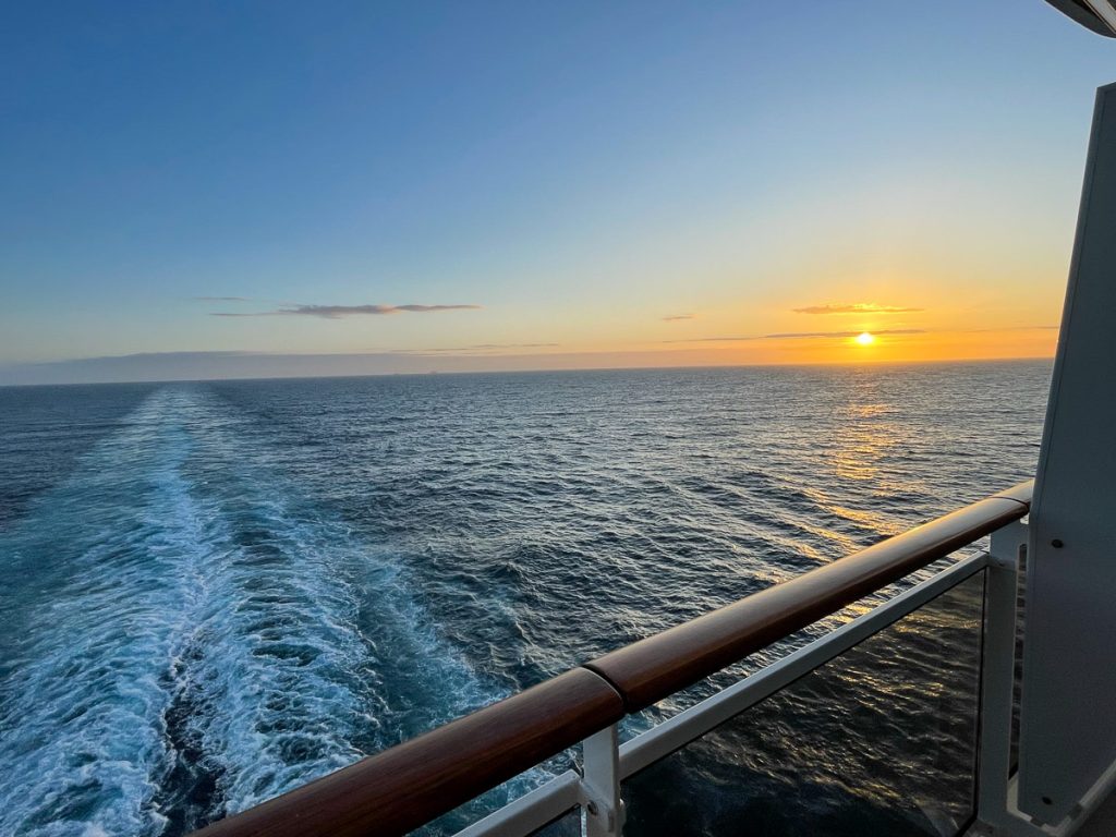 Travel photography - View of a cruise ship wake and the sunset.