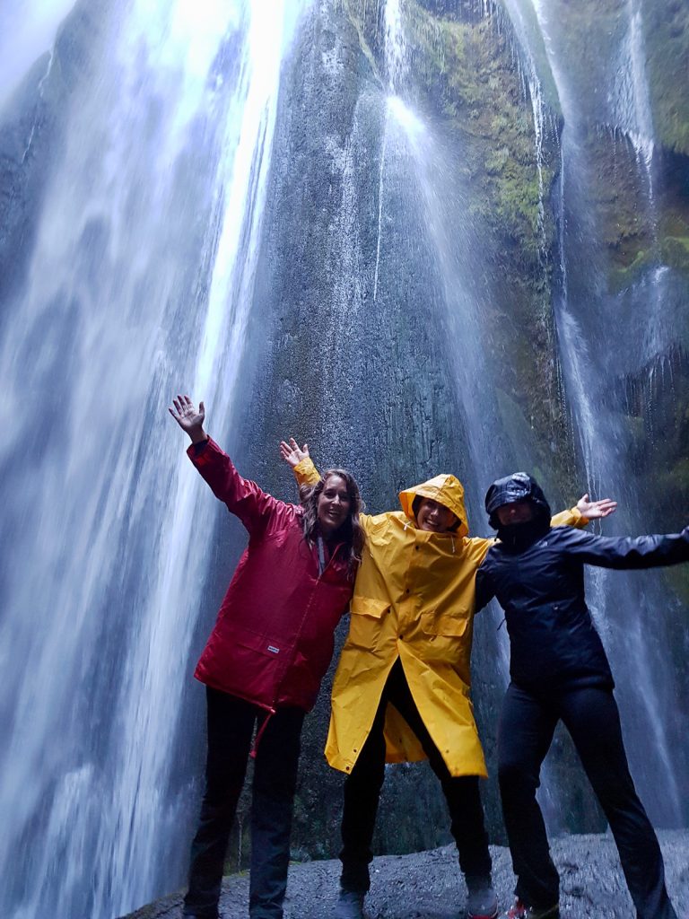 Friends in front of a waterfall on a weekend in Iceland