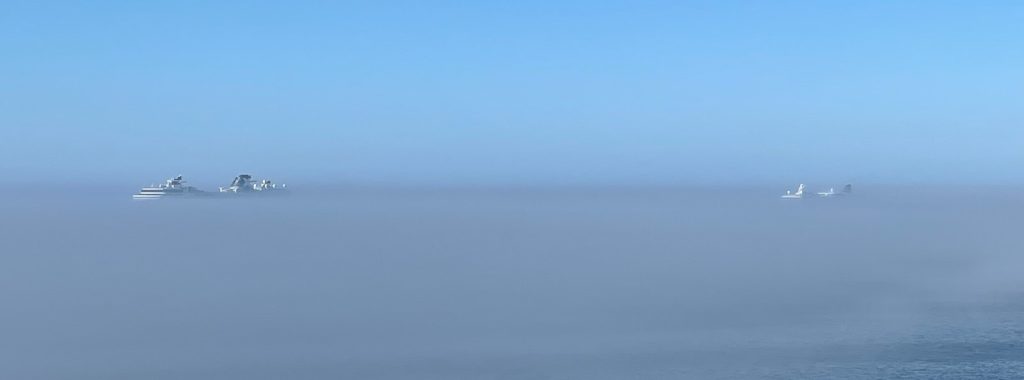 Ghost cruise ships at anchor in the fog.